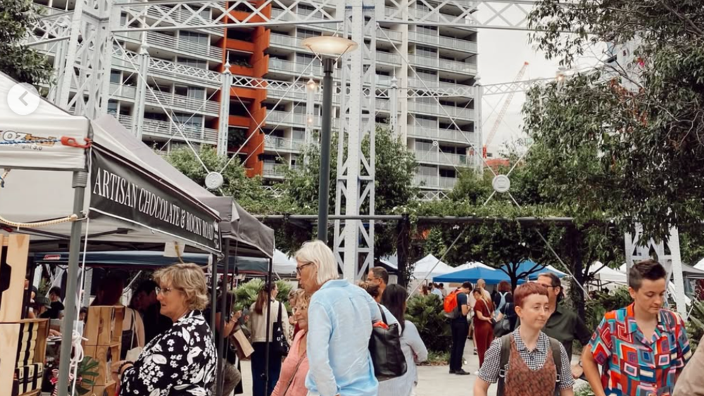Shoppers browsing maker stalls at The Market Folk market at Gasworks Plaza, Newstead